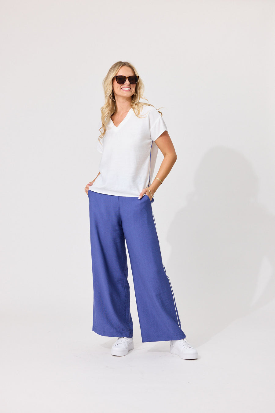 Front view of Lemon Tree Alma Pants in Blue with wide-leg fit and white side seam piping.