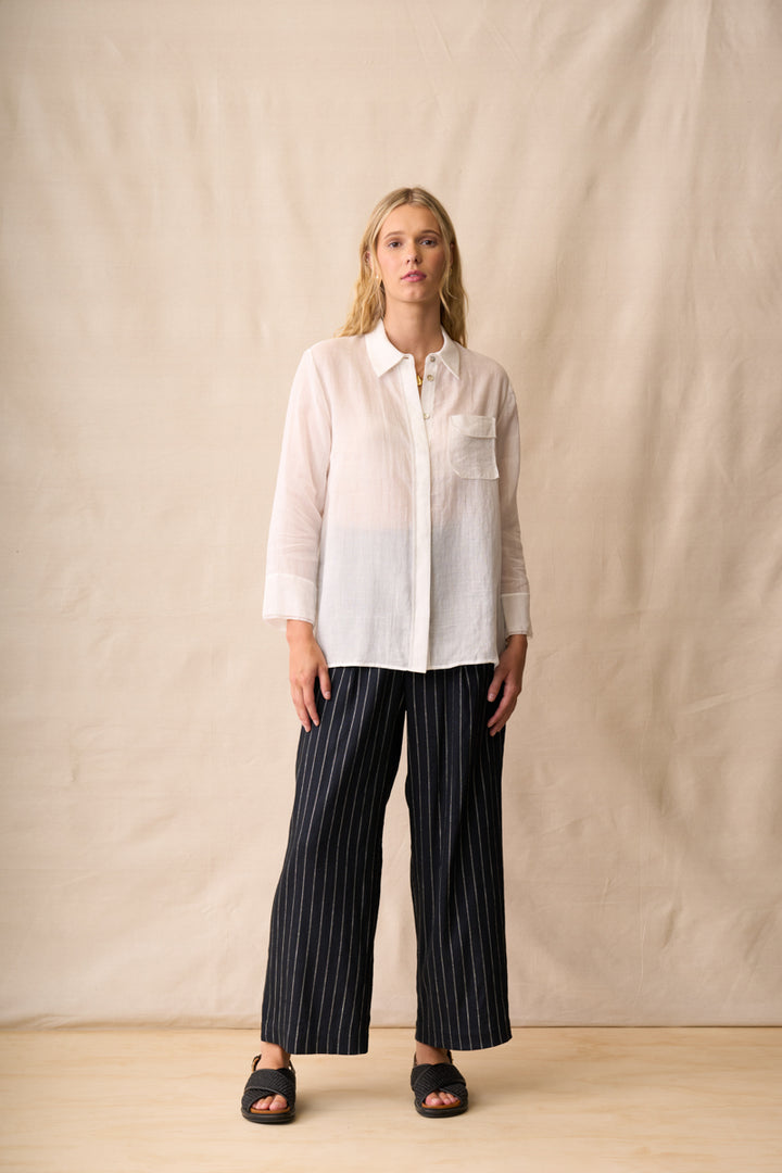 Neris Drew Shirt in White with pinstripe pants, front view.