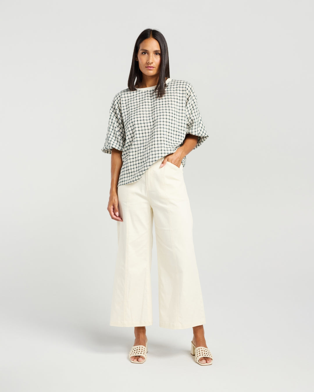 Front view of Kiwi Country Aroha Top in Pine Check paired with off-white wide-leg pants.
