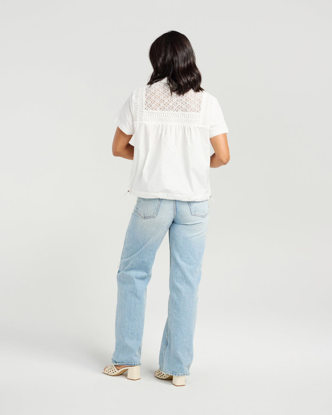 Front view of Kiwi Country White Rosa Shirt paired with light-wash side-stripe jeans.