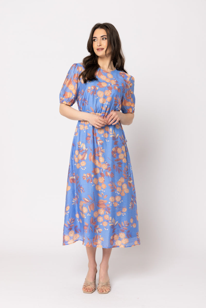 Kiwi Country Guest Dress in Sky Bouquet blue floral dress with short puff sleeves, front view.