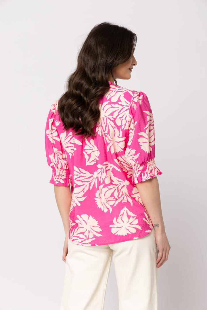 Seeking Lola Gifted Top in Pink Splash pink leaf print blouse with puff sleeves, back view.