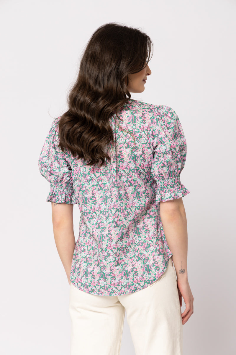 Seeking Lola Honey Blouse in Blooming Garden floral top with puff sleeves, back view.