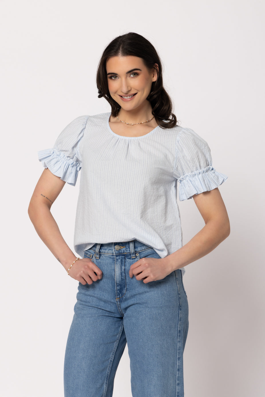 Seeking Lola Vibrant Top in Sky blue striped blouse with ruffle sleeves, front view.