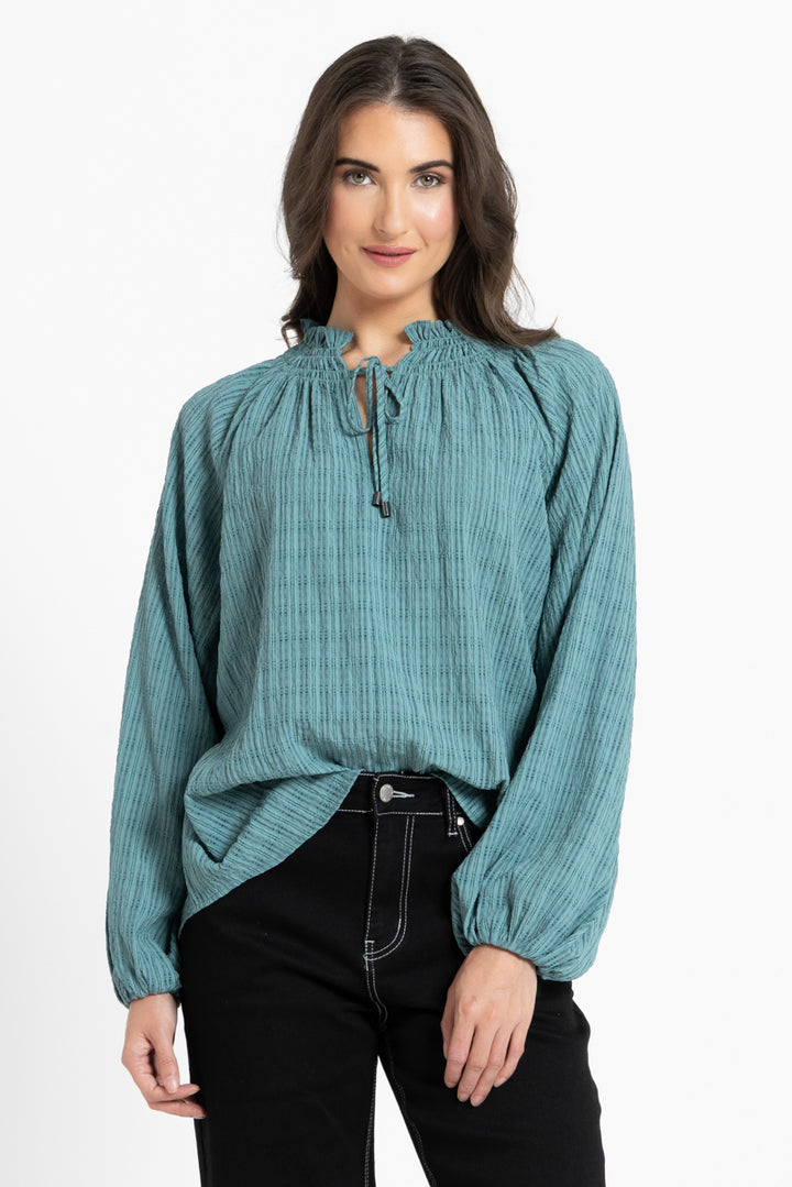 Woman wearing Seeking Lola Warm Teal Rewrite Top